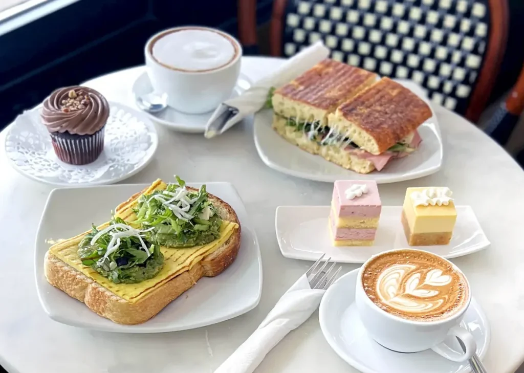 Cafe marble table with lunch, dessert and lattes