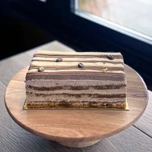 Layered coffee cake with chocolate coffee beans and gold decoration