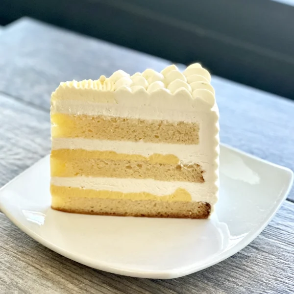 Passionfruit lime cake slice with layers of vanilla sponge, passionfruit curd, and lime cream, Trafiq Bakery Vancouver